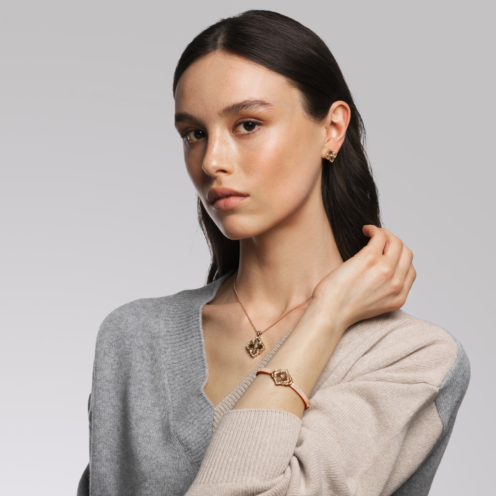 Buccellati Opera Tulle Blue Enamel Gold Earrings handcrafted in 18k yellow gold featuring a vibrant blue enamel centerpiece, delicate radial tulle, and a secure clip for pierced ears. On Model.