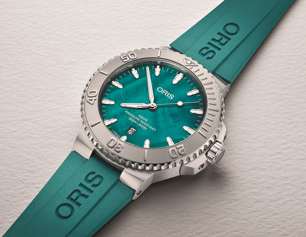 Flat lay product image of the Oris New York Harbor Limited Edition II with aqua green rubber strap and stainless steel case, 300m water resistant.