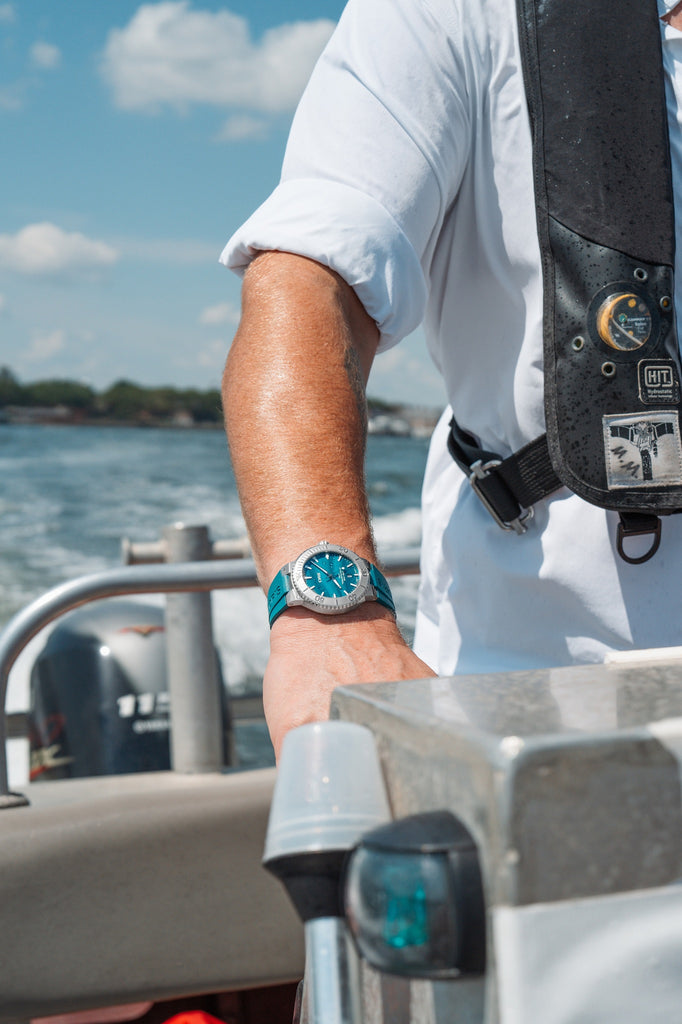 Lifestyle photo of the Oris New York Harbor Limited Edition II worn on wrist, showcasing aqua green strap and dive-ready design.