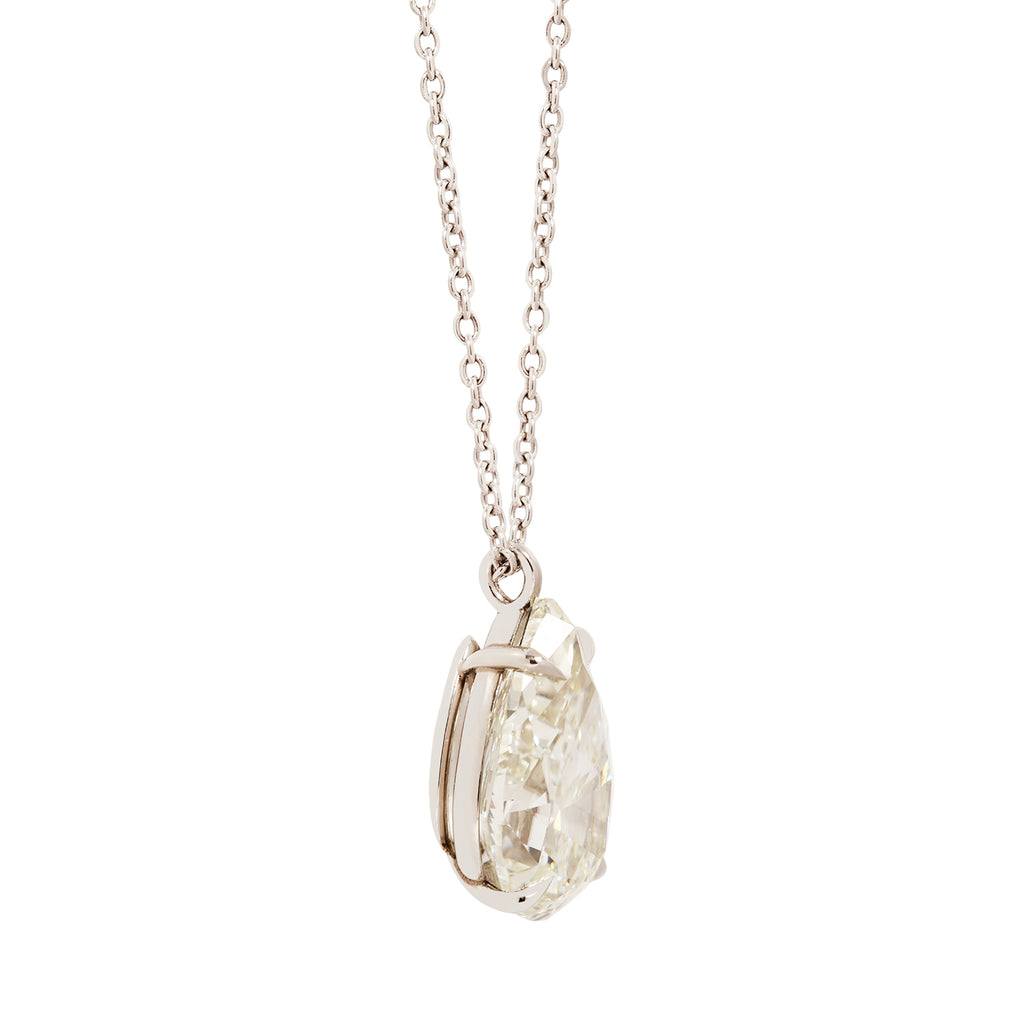 Side view of a solitaire pear diamond drop necklace featuring a 6.05 carat diamond in a platinum setting.