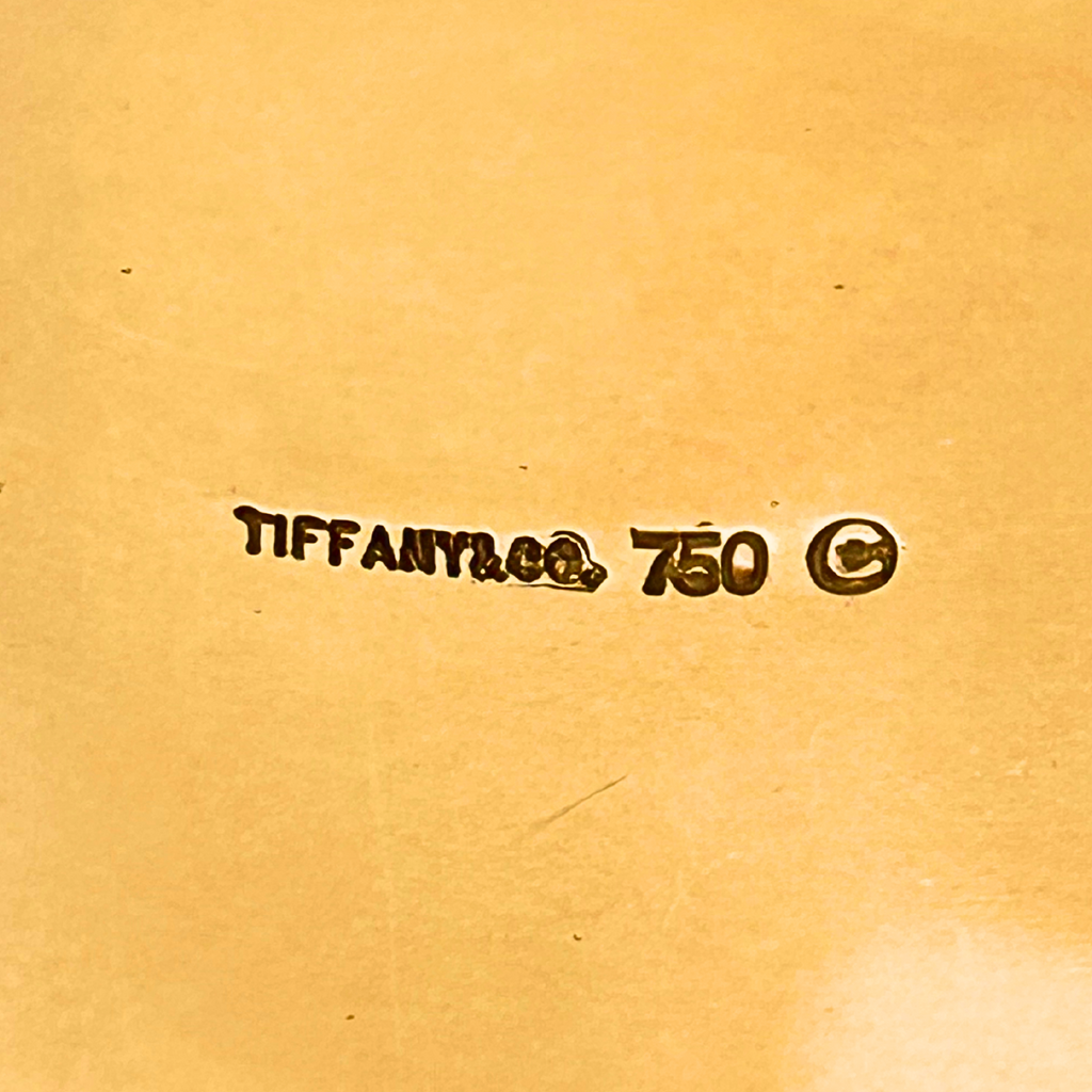 Tiffany stamp view of an Angela Cummings for Tiffany & Co. 18k Domino bangle with mother of pearl and black jade inlay, circa 1990–1995.