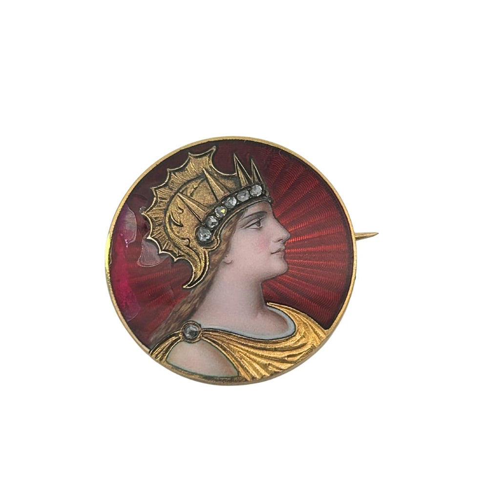 Front view of an antique round brooch with a detailed enamel portrait of a helmeted woman on a radiant red guilloché enamel background.