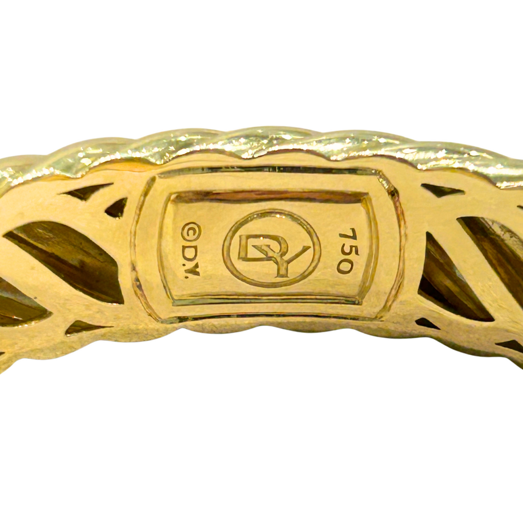 Close-up of hallmark stamped inside the Yurman bracelet, reading DY and 750.