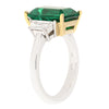 4.81 carat emerald flanked by two trapezoid cut diamond ring in platinum setting