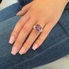 18K gold ring with a pear-shaped Rhodolite garnet, diamond pave band, designed by Barbara Westwood. On model view