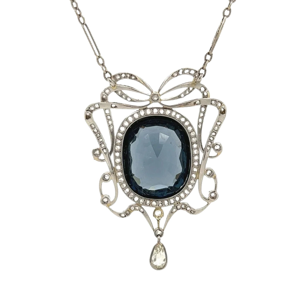 Detailed back view of natural blue spinel and diamond Edwardian pendant necklace with bow motif