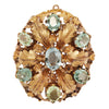 Elegant oval aquamarine pin with seven bead-set stones, engraved oak leaves, floral details, and milgrain accents. Front