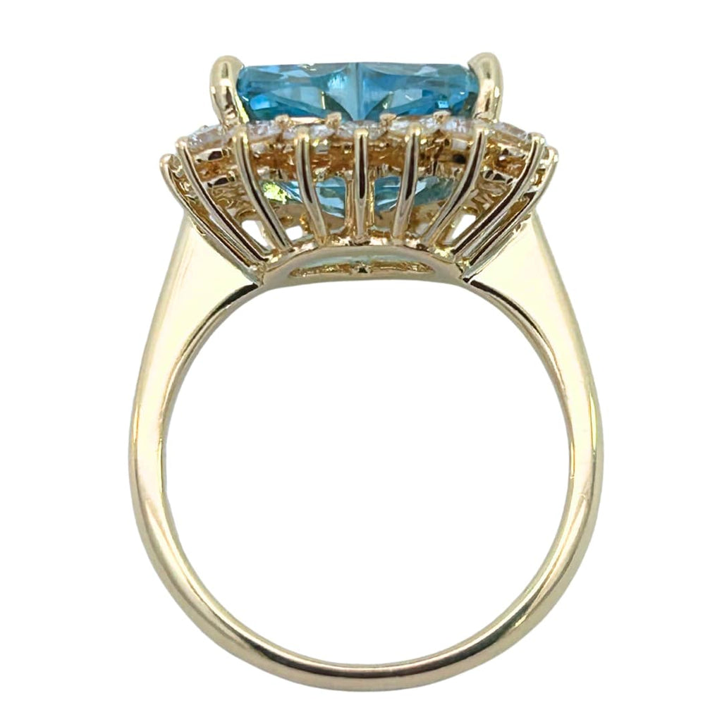 Side view of aquamarine and diamond ring showing raised basket setting