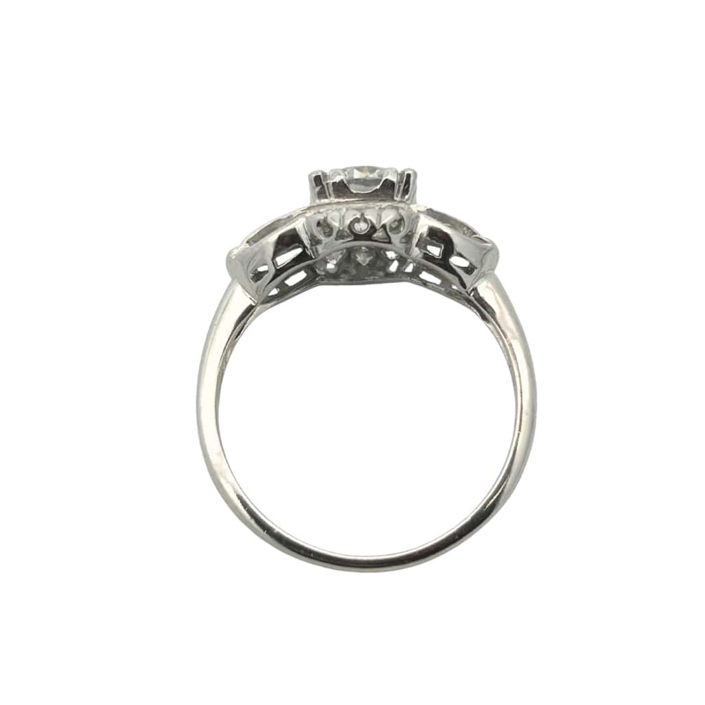 Back view of vintage platinum engagement ring showing illusion head and curved details