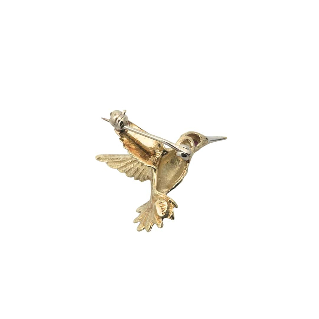 Rear view of a yellow gold hummingbird pin showing detailed craftsmanship and secure pin clasp.