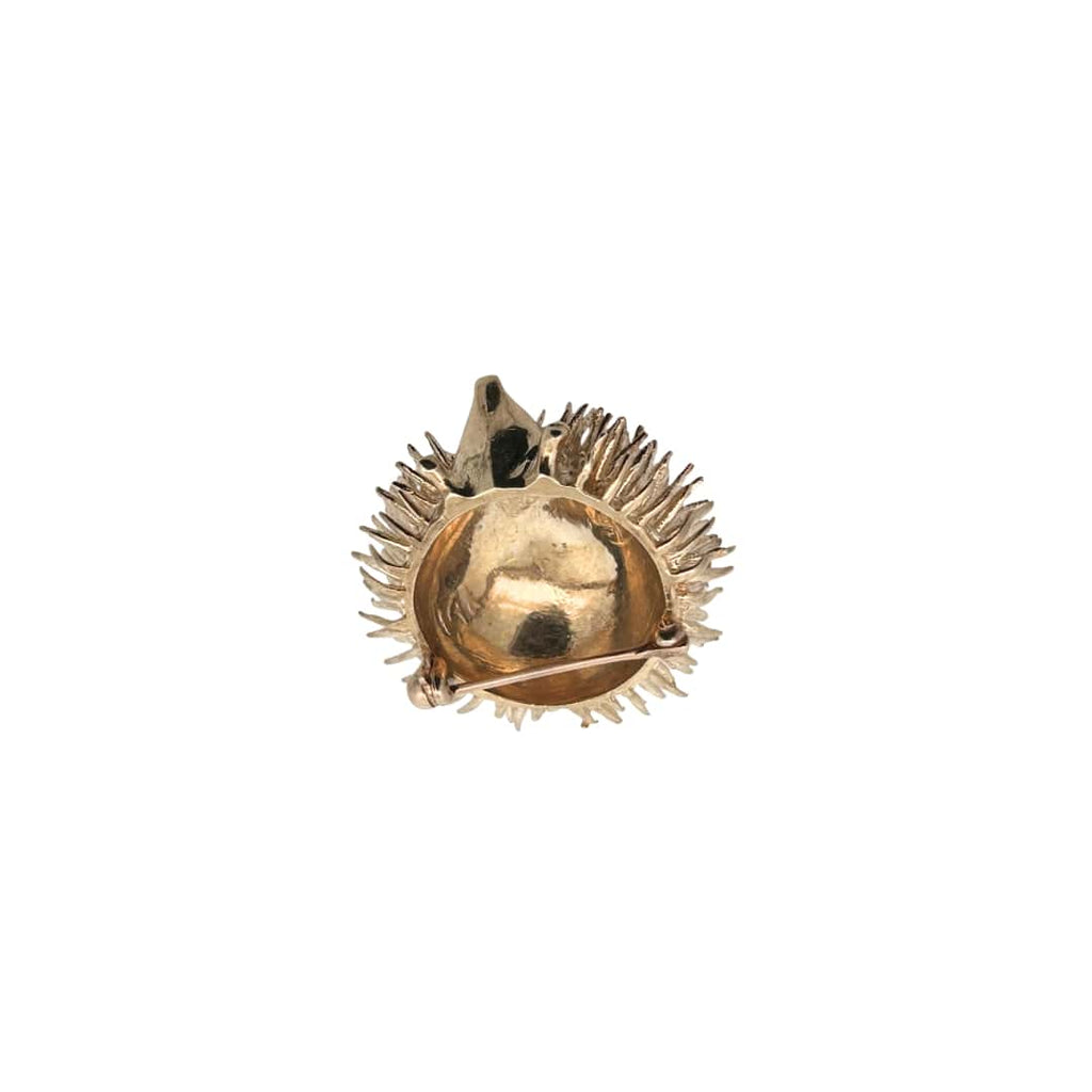Back view of a vintage gold hedgehog pin showing secure pin closure and sculptural gold detailing.