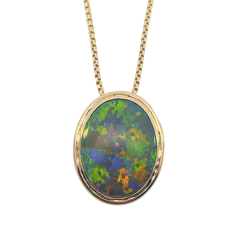 Oval black opal pendant with vibrant multicolor play set in 18k yellow gold bezel