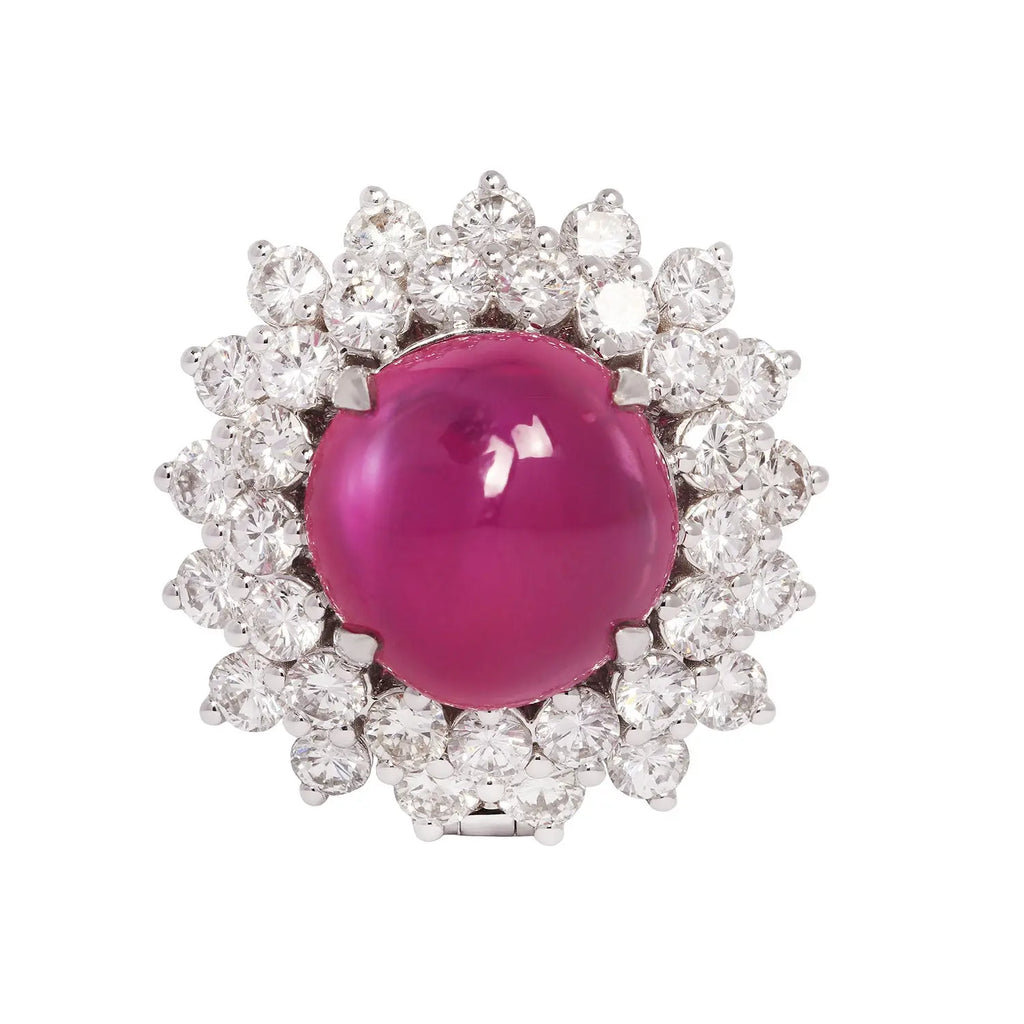 Front view of a platinum ring featuring a no-heat Burmese cabochon pink sapphire encircled by sparkling diamonds.