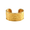 Front view of wide Carrera y Carrera gold cuff with sculpted Romeo and Juliet scene, birds, and architectural details