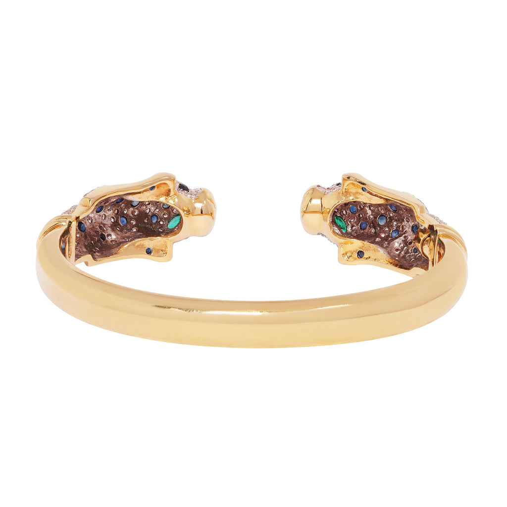 Back view of an 18K yellow gold leopard cuff bracelet featuring pavé diamonds, sapphire accents, and emerald-set eyes.