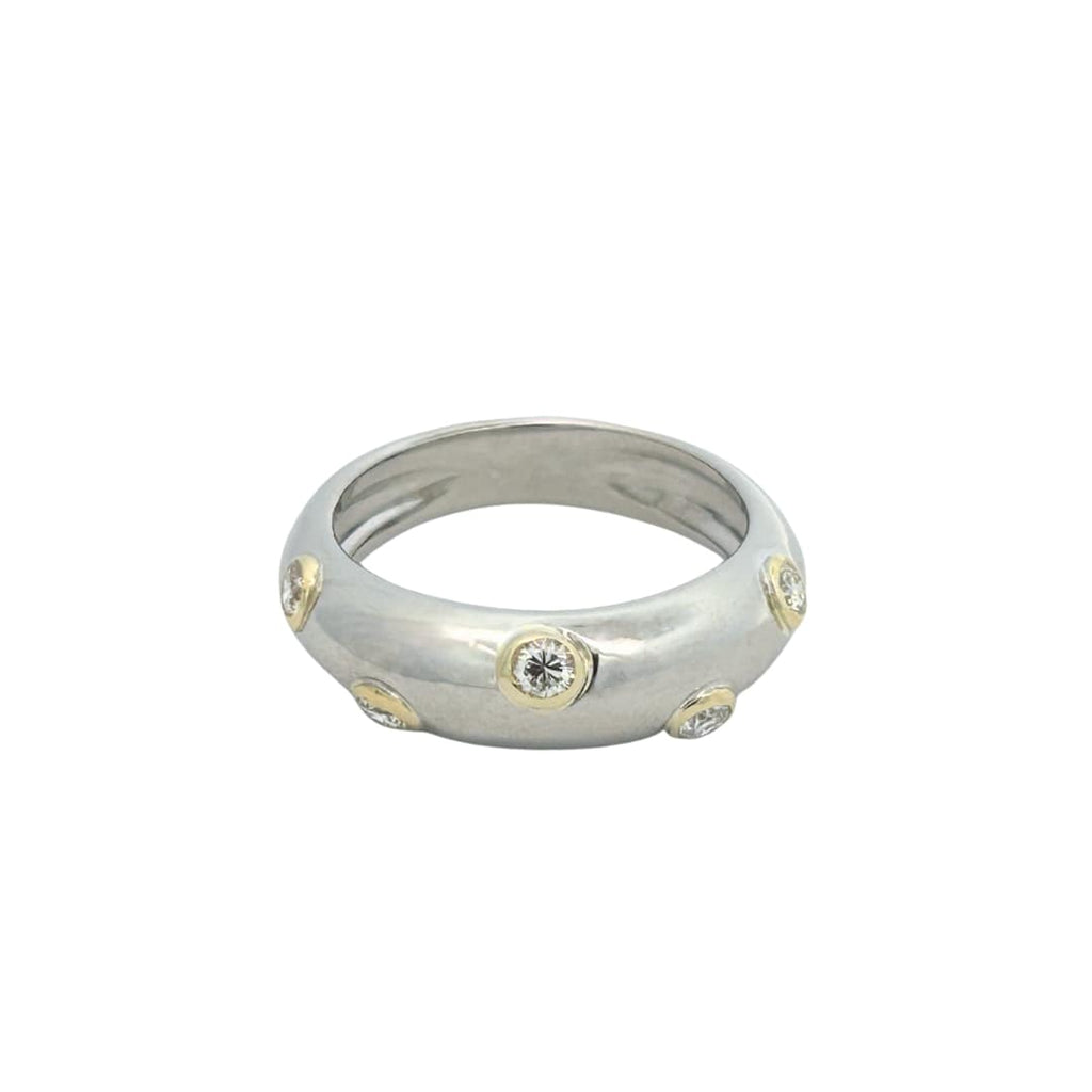 Front view of a tapered dome ring featuring bezel-set round brilliant diamonds in yellow gold on a polished white gold band.