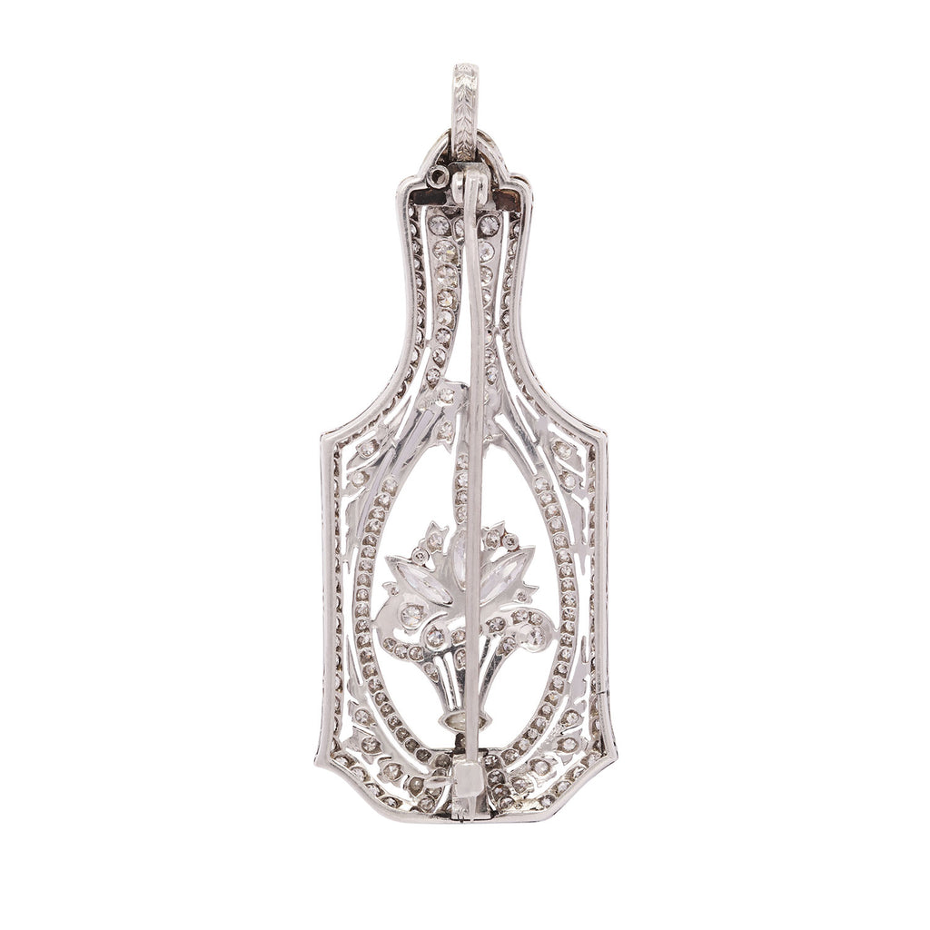 Back view of an Edwardian platinum diamond flower basket pendant and pin featuring openwork design and hinged bail.
