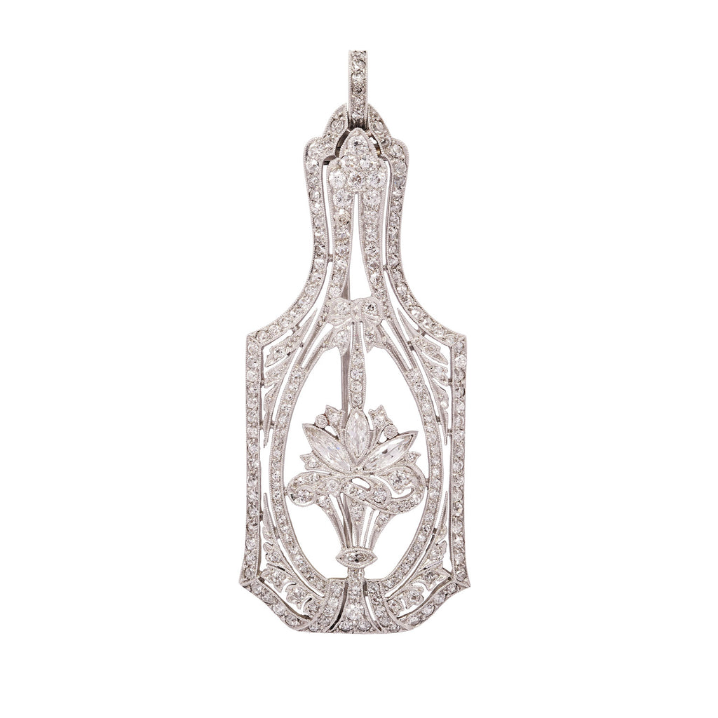 Front view of an Edwardian platinum pendant and pin showcasing a diamond flower basket motif in an open oval frame.