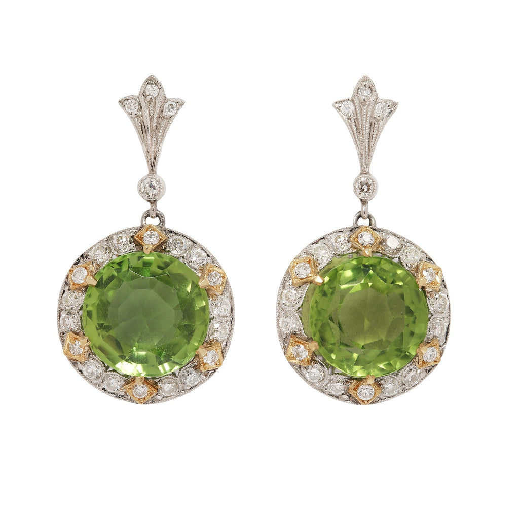 Stunning two-tone 18K gold drop earrings with large round peridots, diamond halo, and secure post-back closure.