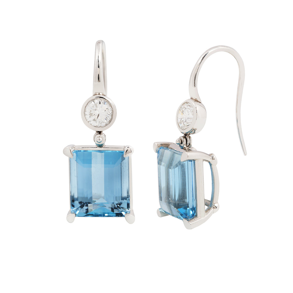 Pair of emerald cut aquamarine earrings with bezel set diamonds and French hooks in platinum, side profile view