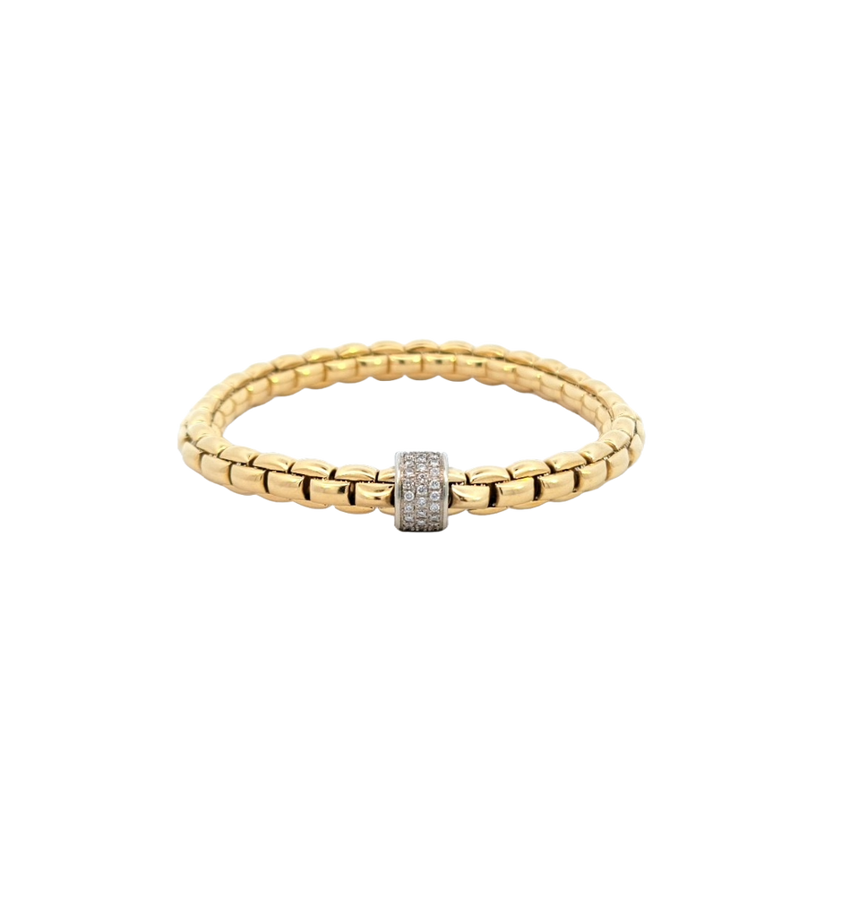 Stretchable gold bracelet by FOPE in yellow gold and a white gold rondel set with pave set diamonds.