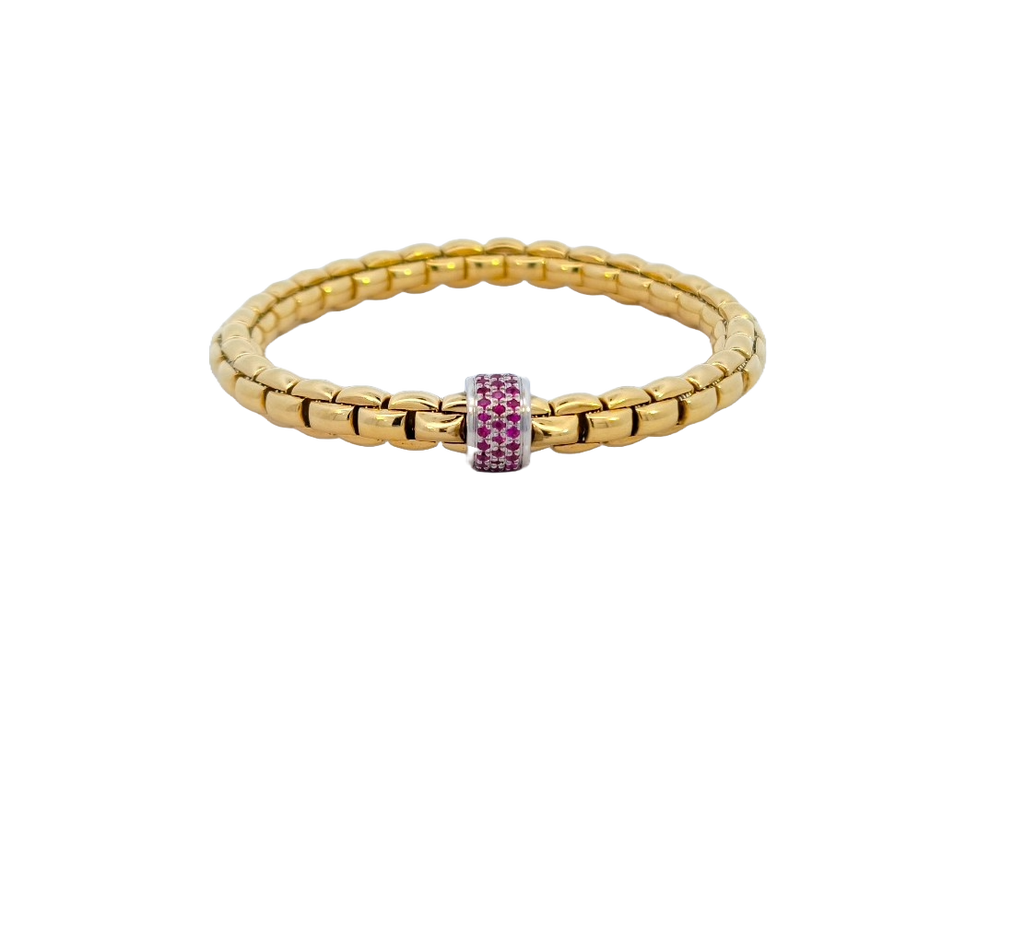 Stackable and stretchable gold bracelet with white gold rondel set with rubies by FOPE