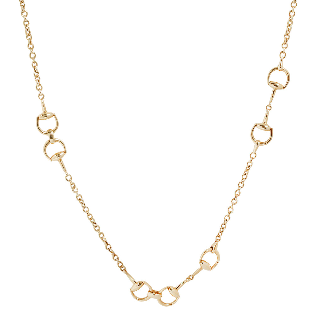 Long, 35.5 inch gold necklace by Gucci featuring repeating iconic interlocking horsebits dispersed through the necklace. 