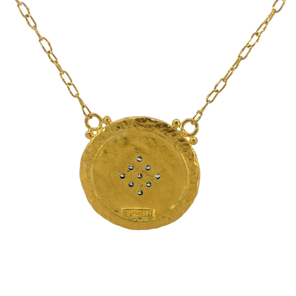 Back view of hammered gold pendant showing artisan texture and diamond setting