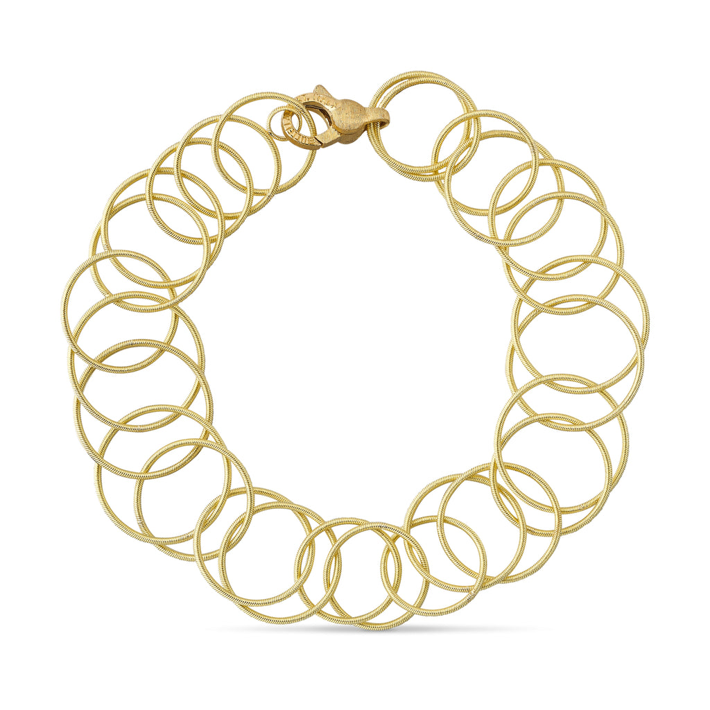 Buccellati Hawaii Yellow Gold Bracelet showcasing hand-twisted, interwoven gold circles in a luxurious design, a handcrafted Italian jewelry masterpiece.