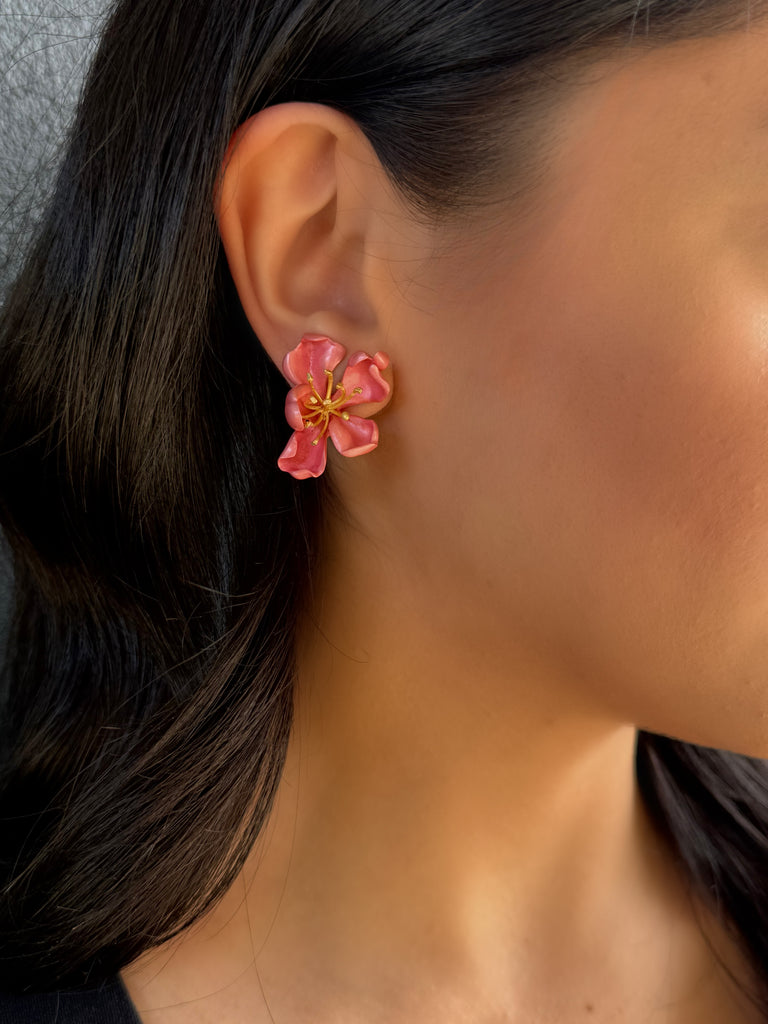 JAR (Joel Arthur Rosenthal) Pink enamel almond blossom clip on earrings on model with black hair.