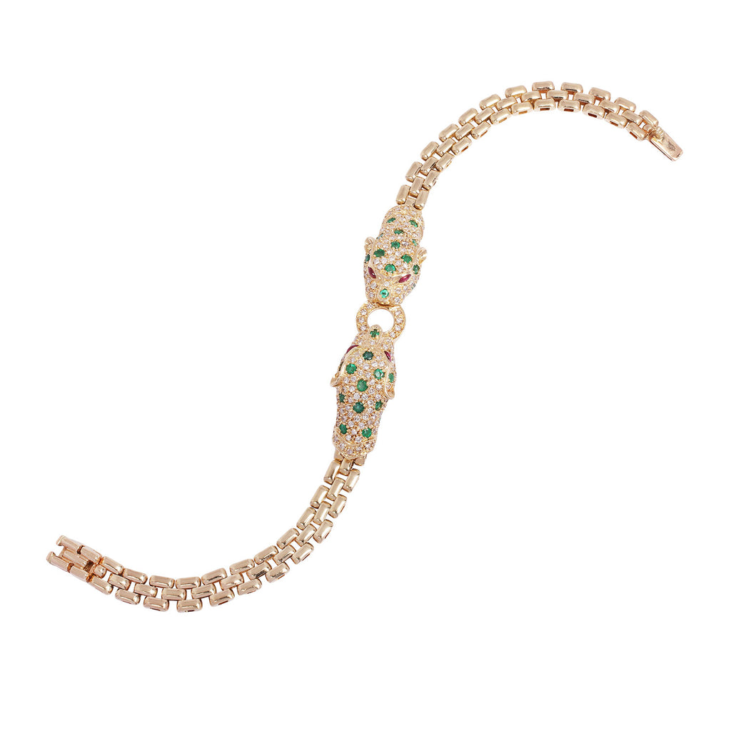 Side profile of a luxury leopard bracelet crafted in 14K yellow gold with pavé diamonds, emerald detailing, and ruby eyes.