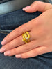 Masriera 18K gold snake ring with yellow-orange enamel, diamond accents, Art Nouveau revival design. On model.