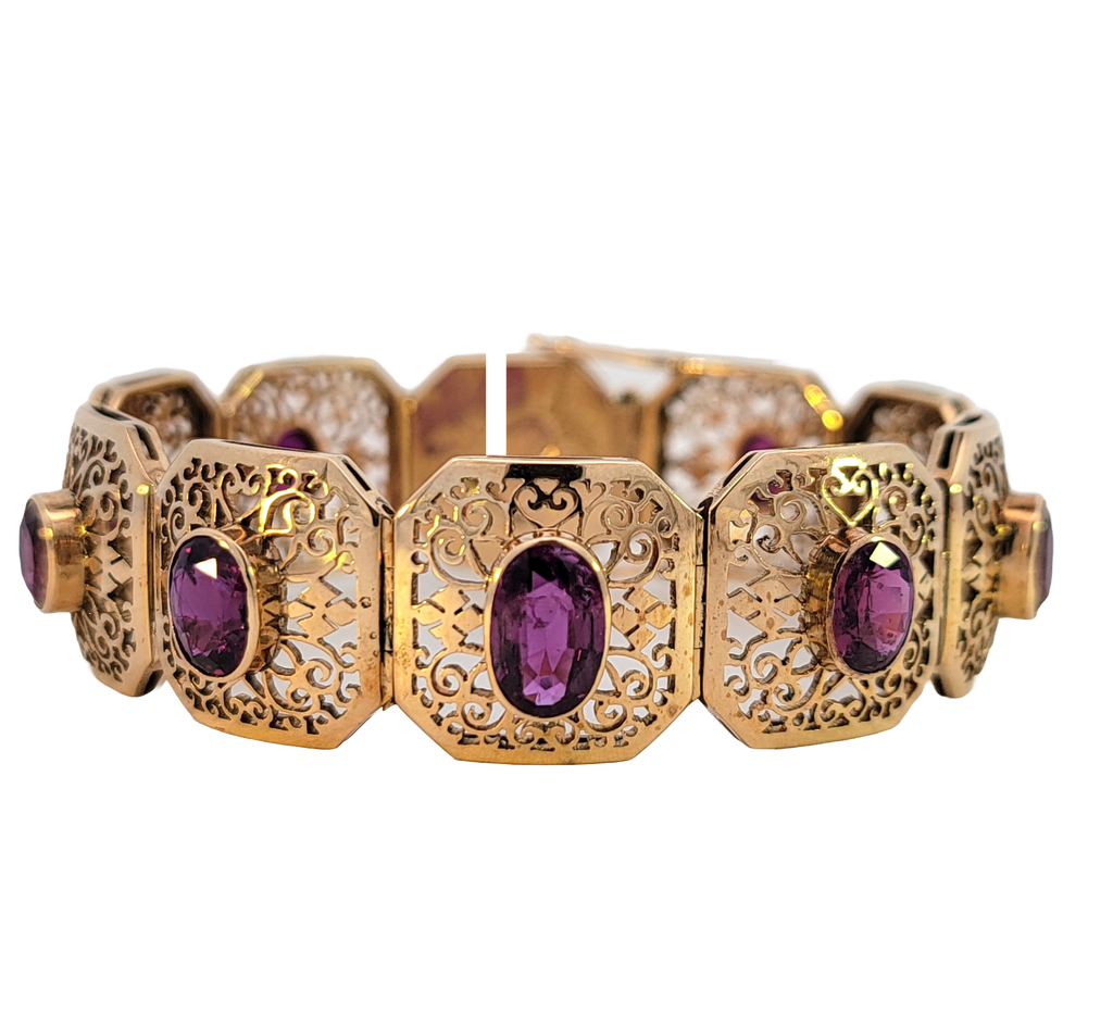 Openwork gold square link bracelet with 10 oval bezel-set magenta sapphires.