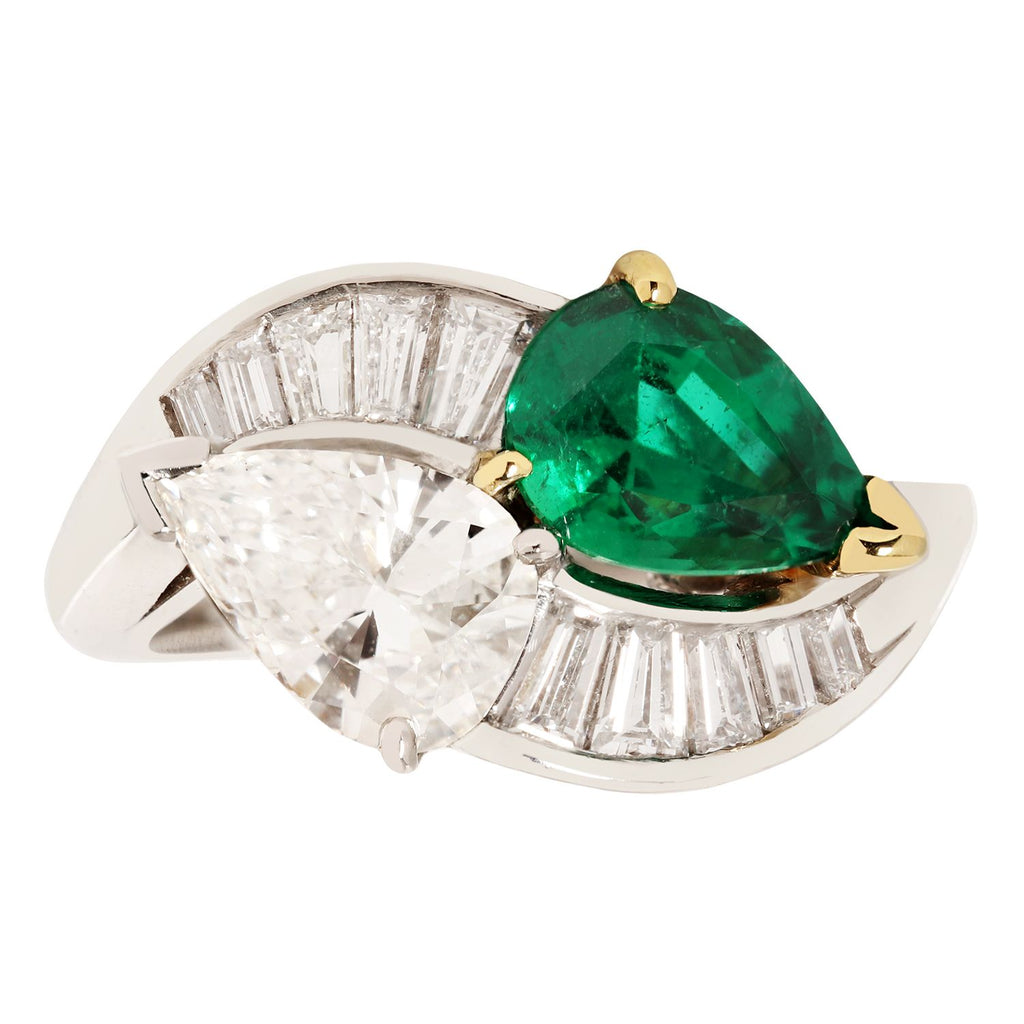 By-Pass ring with pear diamond and pear Zambian emerald set in platinum with tapered baguettes down the sides.