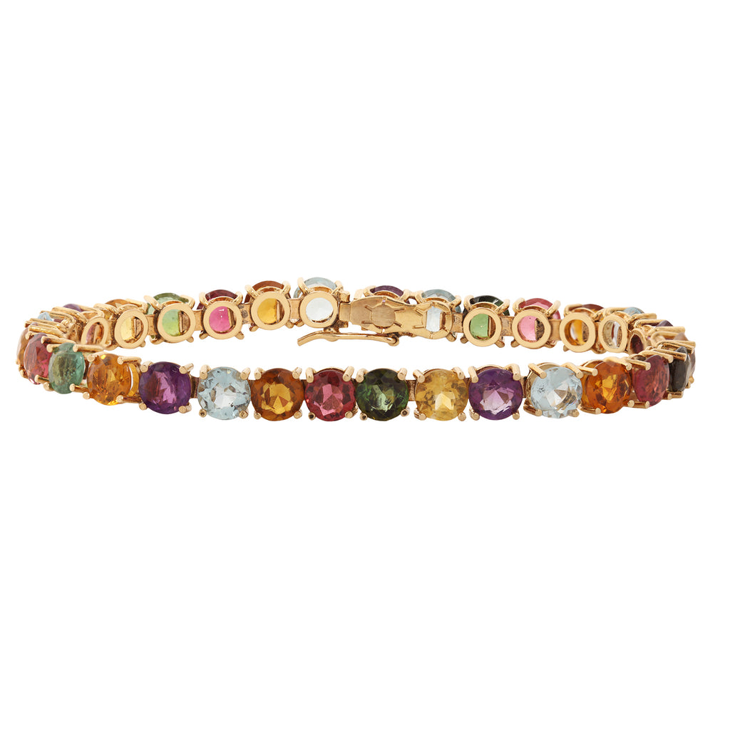 Full view of a multi-gemstone 18k yellow gold tennis bracelet.