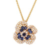 Oscar Heyman sapphire and diamond floral brooch worn as a pendant on an 18k yellow gold chain.
