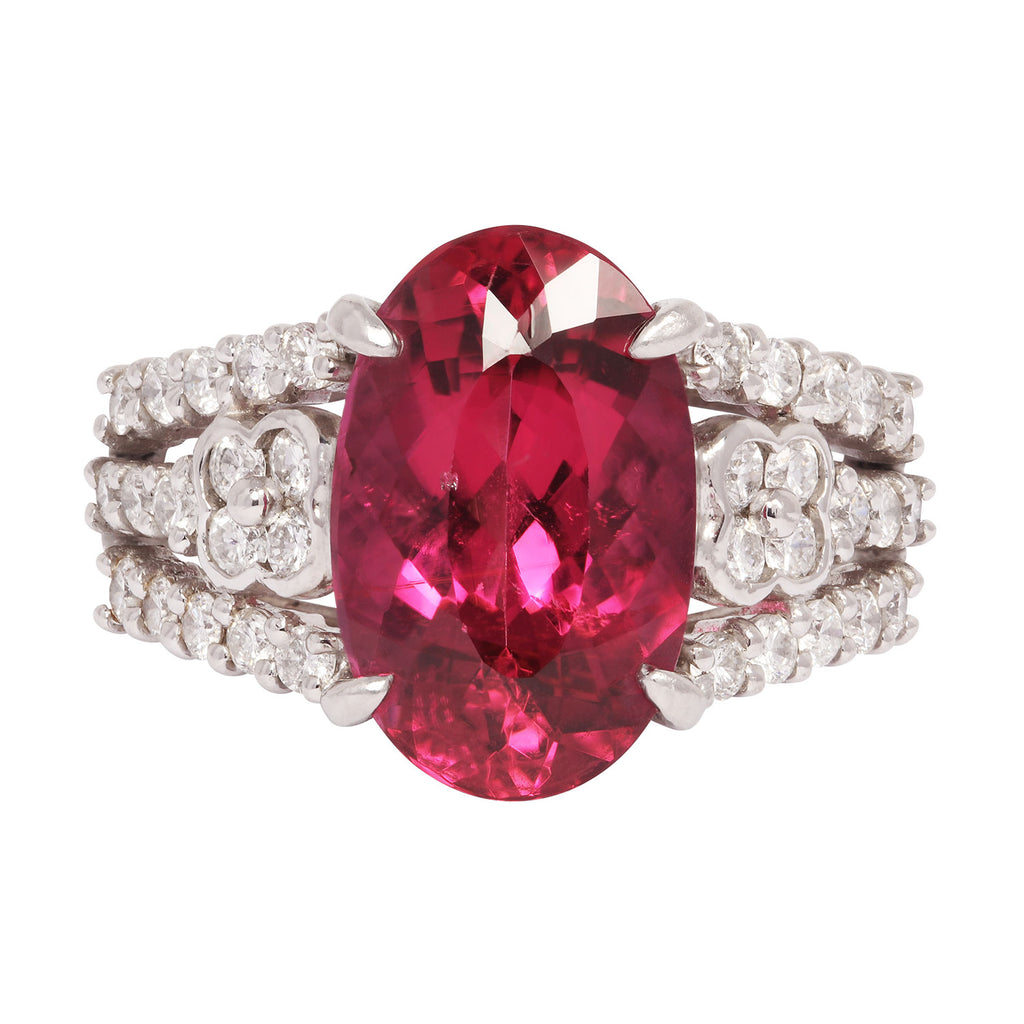 Front view of a platinum ring showcasing a vivid oval rubellite tourmaline framed by brilliant round diamond accents.