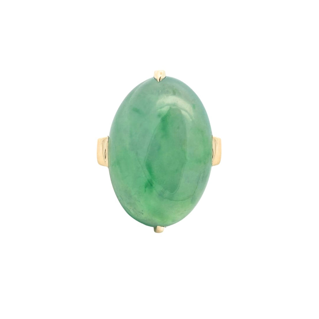 Top view of an oval jade cabochon ring set in polished 18k yellow gold with a smooth, luminous green jade center.