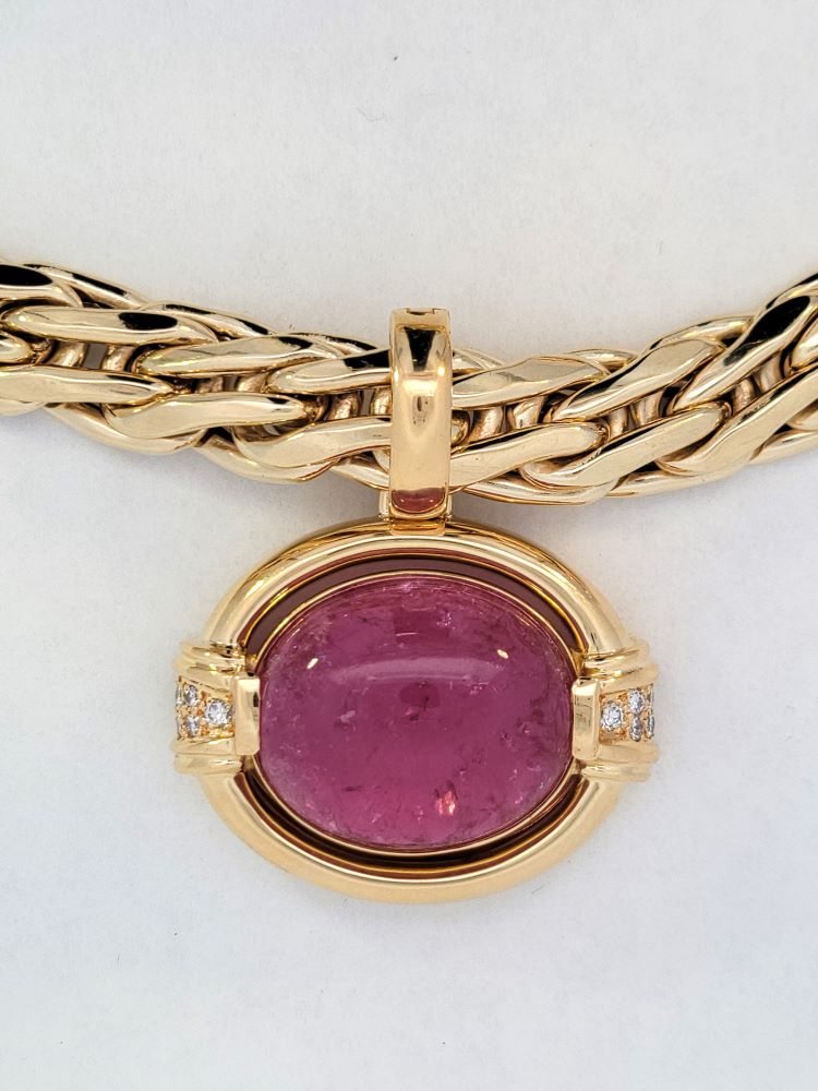 Gump's 18K gold pendant with a pink horizontal tourmaline cabochon, diamond accents, and a hinged bail design. On chain.