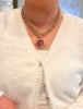 Gump's 18K gold pendant with a pink horizontal tourmaline cabochon, diamond accents, and a hinged bail design. On model.