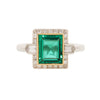 Rectangular Columbian emerald set in yellow gold bezel and framed with diamond.