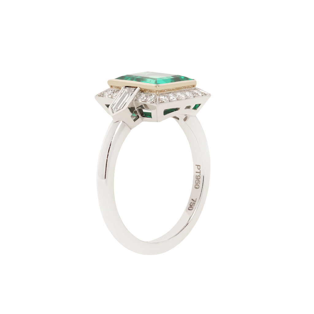Rectangular Columbian emerald set in yellow gold bezel and framed with diamonds in platinum frame, side view.