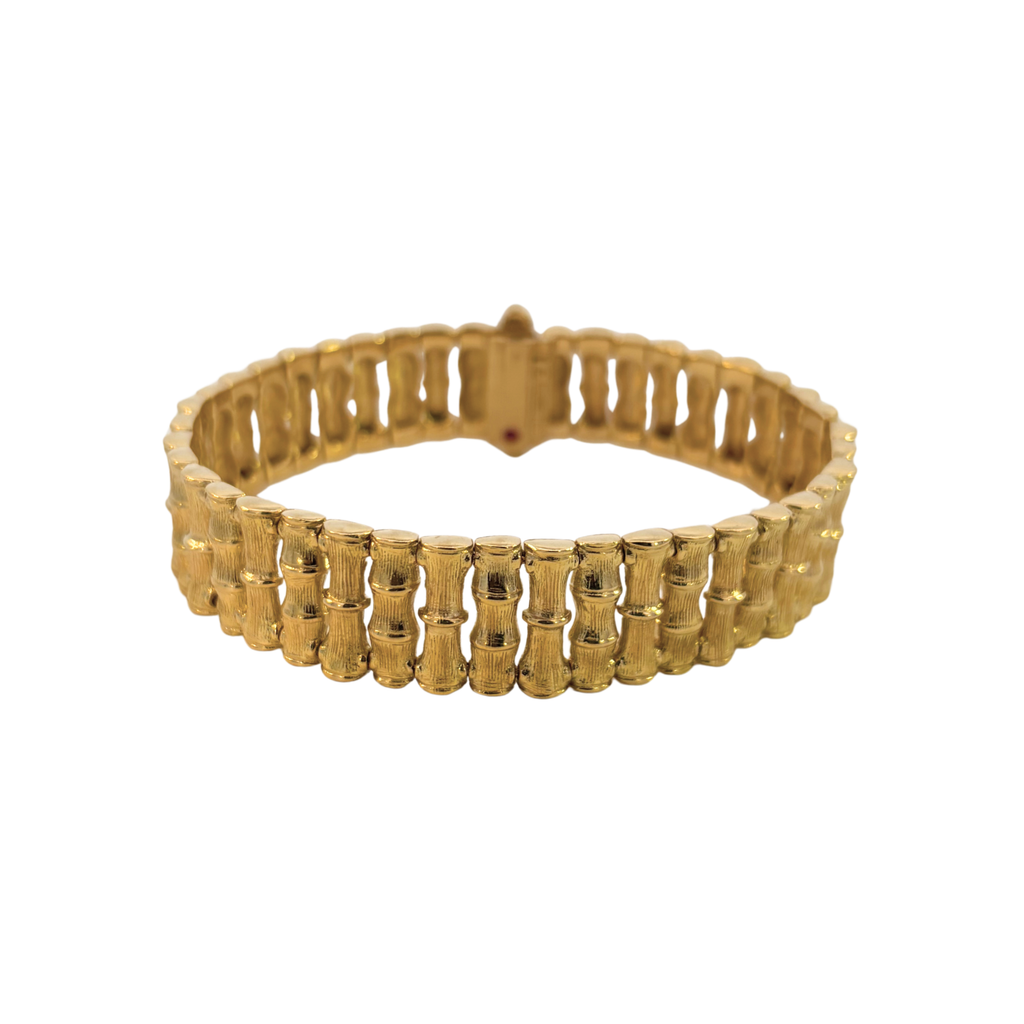 Reverse view of a Roberto Coin 18K gold bamboo bracelet with a signature hidden ruby beneath the clasp