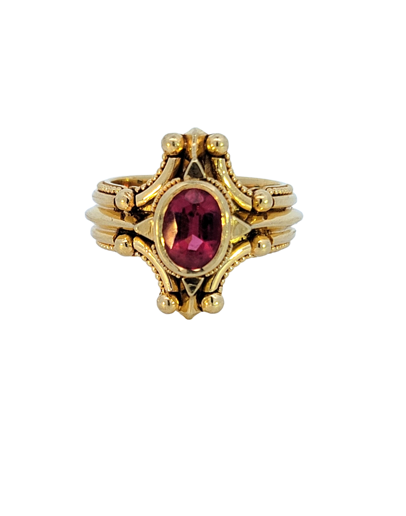 Bold 18K gold ring with oval Rubellite, compass-inspired granulation design, size 7, striking statement piece.