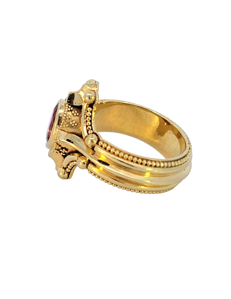 Bold 18K gold ring with oval Rubellite, compass-inspired granulation design, size 7, striking statement piece. Side view