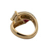 Interior view of an 18K gold ruby and diamond bypass ring showing the open gallery, polished band and pavé diamond shoulders.
