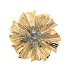 Yellow gold starburst petal brooch with blue sapphire cluster center front view