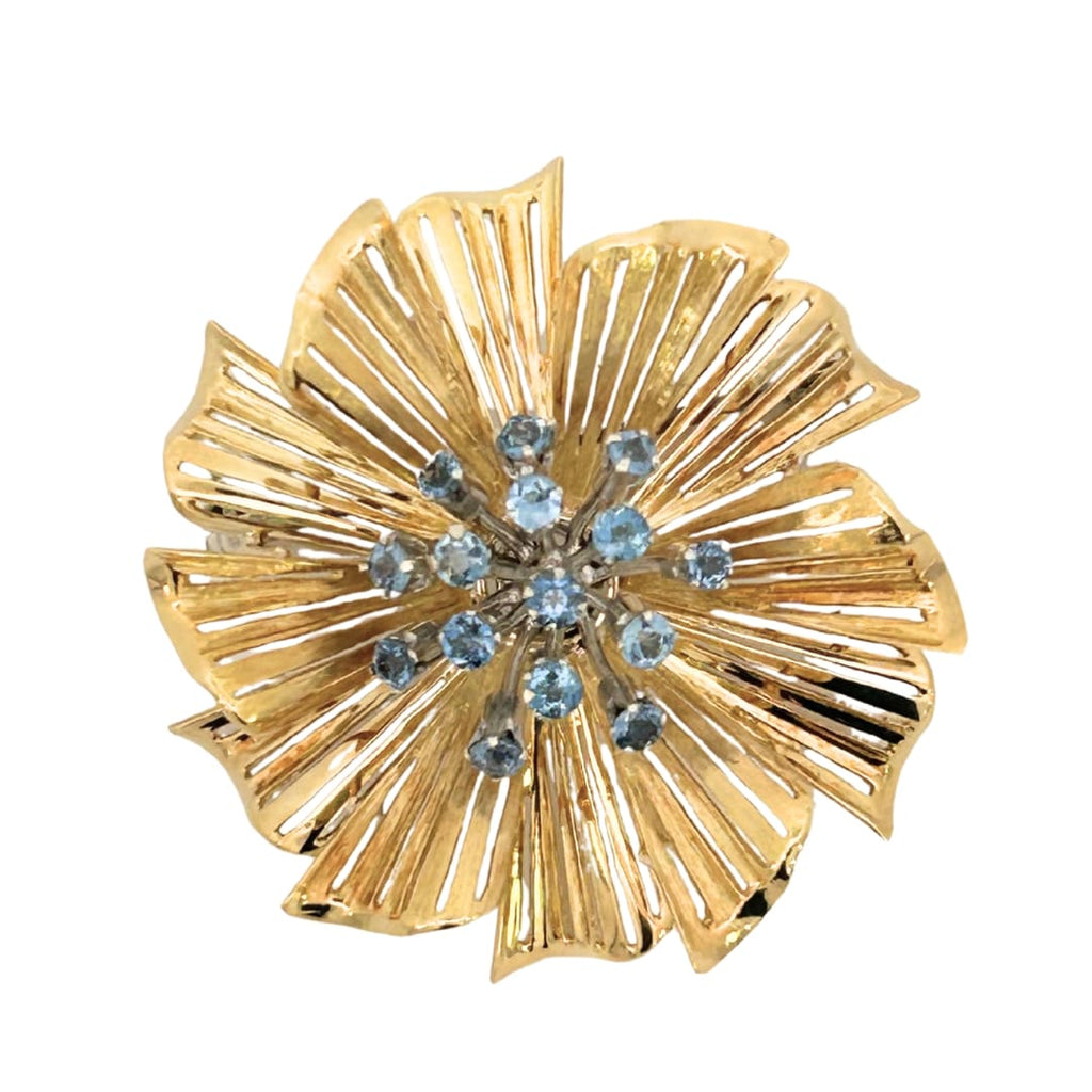 Yellow gold starburst petal brooch with blue sapphire cluster center front view