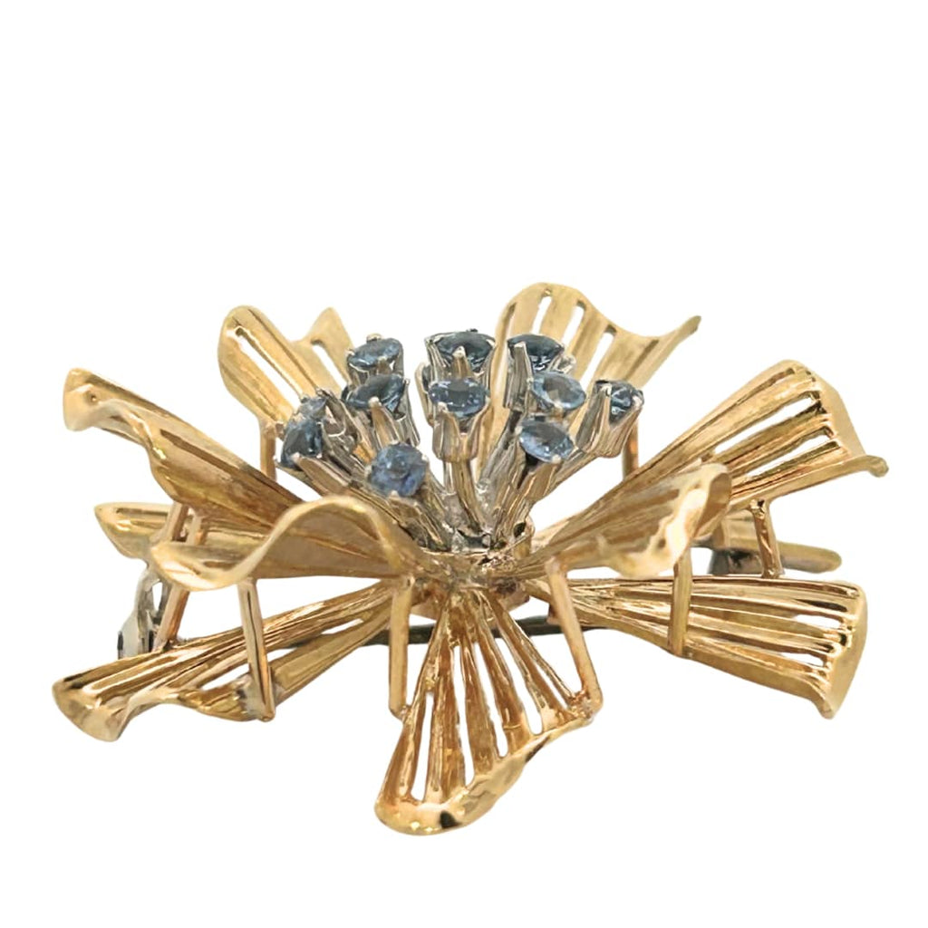 Side profile of sapphire cluster and openwork gold petal design