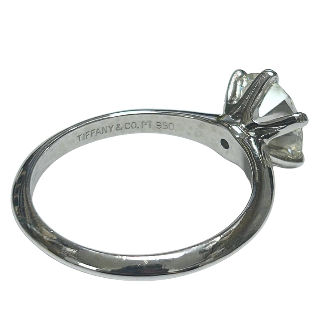 Angled view of Tiffany & Co. platinum engagement ring with stamp with 2.41ct round brilliant diamond.